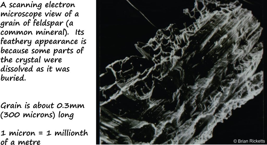 Scanning Electron Microscope view of a feldspar grain, seriously etched (dissolved) along cleavage and twin planes. This process goes part way to creating secondary porosity