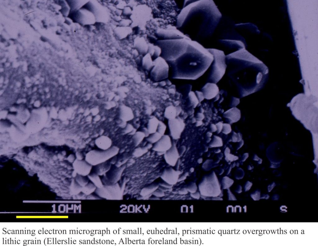 SEM of epitaxial quartz prisms growing on a lithic grain