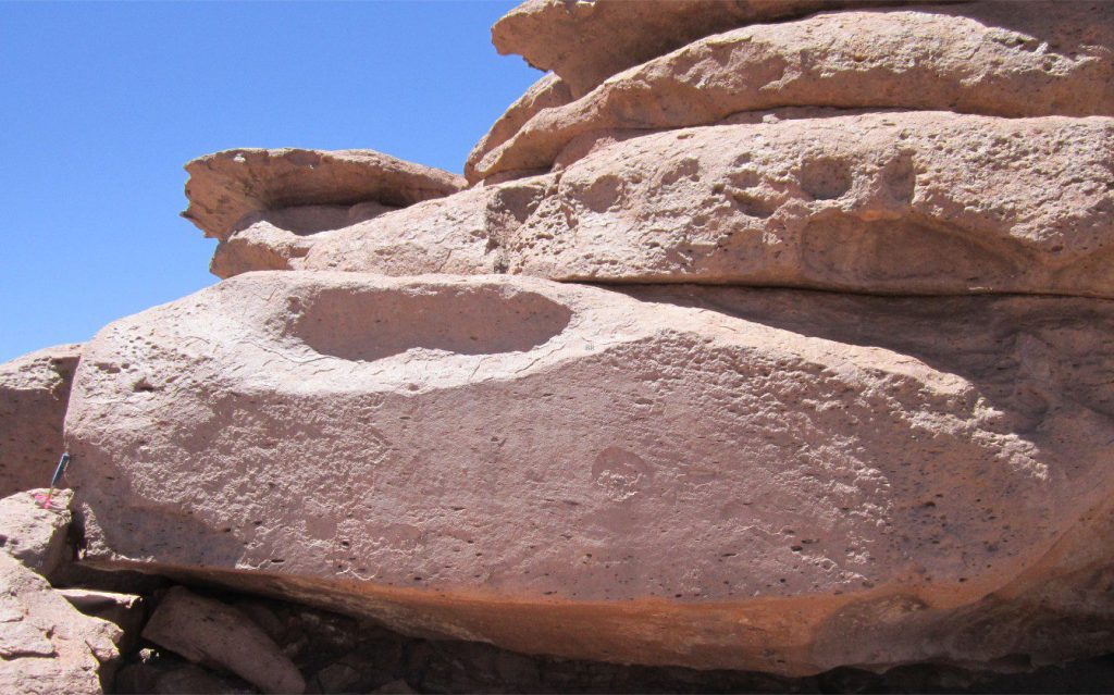 A closer look at the welded, flattened pumice, accentuated by weathering (same unit as image above). There is a crude alignment of the flattened clasts. Hammer lower left.