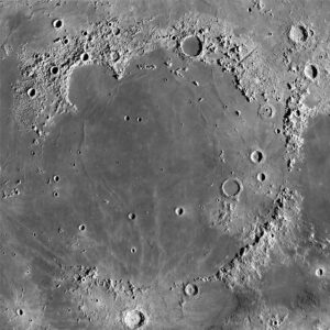 Mare Imbrium is the youngest lunar mare, dated from Apollo 15 samples at 3.85 billion years. It is also the largest on the Moon’s nearside at 1160 km diameter. It is the ‘type’ area for the Lunar Imbrium Period. Remnants of the highly degraded basin ring occur on the lower right. Like most lunar mare, it is relatively smooth and flat with few craters compared with the surrounding highlands. Imbrium is thought to have formed during impact from a planetesimal at least 240 km wide (Schultz and Crawford, 2016) and subsequently filled with basaltic lava. Image credit: NASA Lunar Reconnaissance Orbiter mosaic, 2014. 