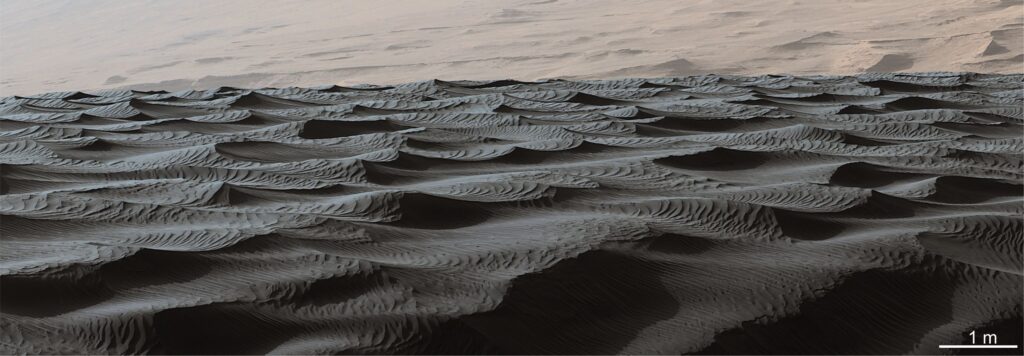 Two generations of modern bedforms in Bagnold dune field, Gale crater, taken by the Mastcam on Mars Curiosity Rover, Sol 1192. The larger wind-blown dunes are about 3 m wavelength, with amplitudes approaching a metre. Ripple bedforms are superimposed on the larger structures. Image Credit: Cropped from PIA20755 NASA/JPL-Caltech/MSSS. 